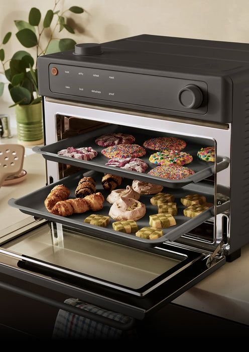 Multi-function kitchen appliance with various food items on trays