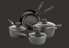 A set of nonstick black cookware, including two saucepans with lids, a deep pot with lid, and two frying pans, all with black handles, arranged on a dark background.