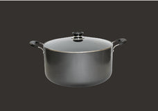 A large black cooking pot with two handles and a transparent glass lid, set against a plain dark background.