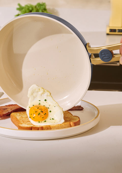 Fried egg on toast with a frying pan in the background