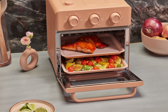 a healthy air fryer recipe with salmon and vegetables cooked in the non toxic air fryer wonder oven