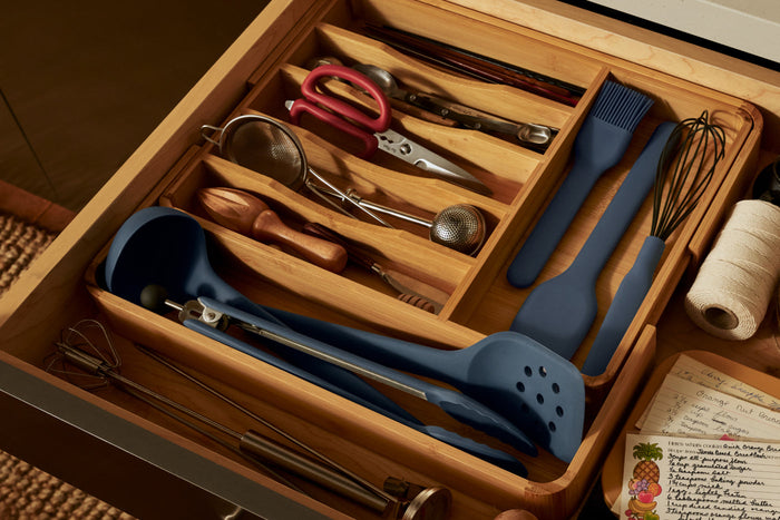 Cooking utensils in a wooden drawer organizer