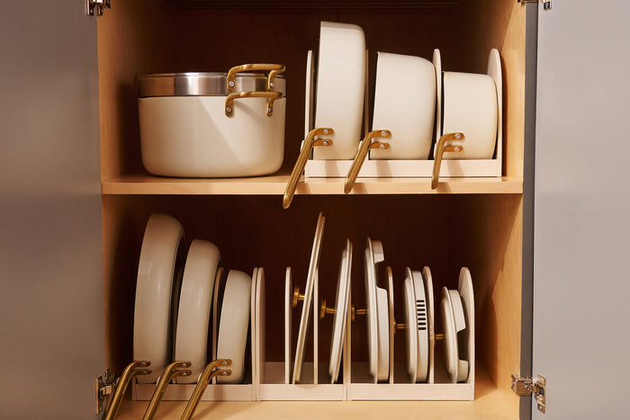 White cookware in a wooden cabinet