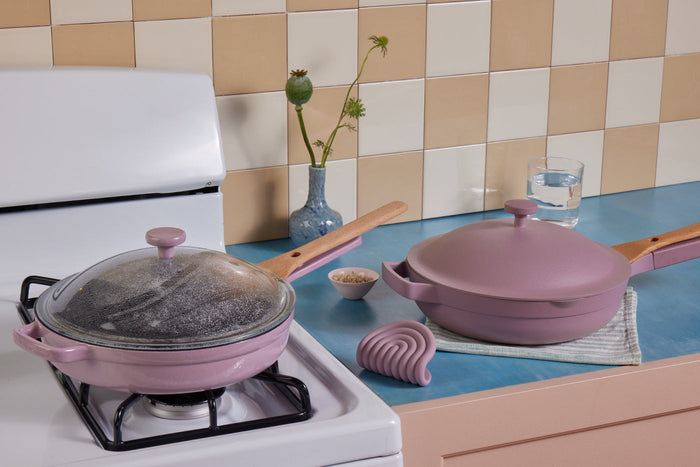 Two lavender pans on a stove top