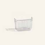 A small, clear, rectangular plastic container with no lid, placed on a plain white background.