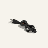 A black power cord with a two-prong plug on one end and a rectangular connector on the other, coiled neatly against a plain, light background.