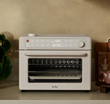White toaster oven on a kitchen counter with a neutral background