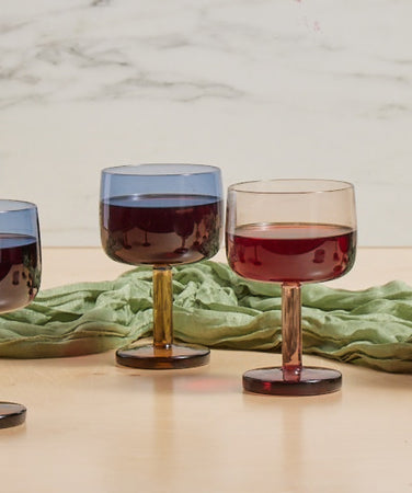 A collection of blue and orange and pink and orange Party Coupes on a table