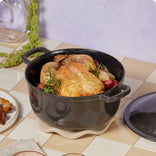 black cast iron perfect pot with roasted chicken