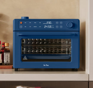 Blue Our Place countertop oven with a digital display showing 230 degrees and 24:59.