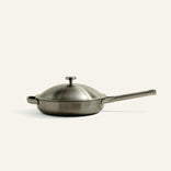 A stainless steel Titanium Always Pan Pro 10.5″ 2.0 skillet with a matching lid and a long handle.