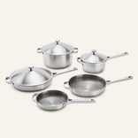 Titanium Pro Cookware Set+ 2.0 stainless steel cookware including a Dutch oven, saucepan, sauté pan, and two skillets, all with matching lids.