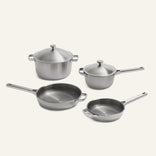 Two stainless steel saucepans with lids, a large frying pan, and a smaller frying pan from the Titanium Pro Cookware Set 2.0.
