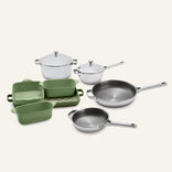 Titanium Pro Cookware + Bakeware Set 2.0 including stainless steel pots and pans, green ceramic bakeware, and a checkered tray.