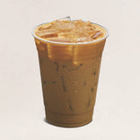Plastic cup of iced coffee on a beige background