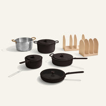 Set of black cookware including pots and pans on a white background