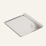 silver crumb tray on a white background